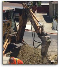 Hydraulic rock breaker (hoe ram) in use